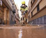 A firefighter sweeps away mud after floods in Paiporta, Spain on November 7, 2024. -  Alberto Saiz, AP