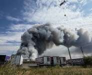 A firefighting helicopter prepares to drop a load of water during a fire at Russian e-commerce firm Wildberries logistics complex near the town of Podolsk, outside Moscow on August 16, 2026. -  Tatyana Makeyeva, AFP