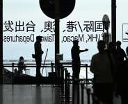 File photo: A security guard guides passengers at Beijing International airport on July 6, 2025. -  Wang Zhao, AFP