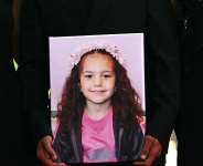 A person holds a photo of Hind Rajab, the 5-year-old Palestinian girl who was killed in January 2024, during a screening of The Voice of Hind Rajab on September 3, 2025. -  Stefano Rellandini, AFP