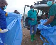 A health worker sprays a colleague with disinfectant after taking part in a burial service for a 3-year-old who died of Ebola in Bunia, Ituri province of eastern Congo, on August 18, 2026. -  Dieudonne Dirole, AP Photo