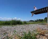 A woman lies on a jetty that ends at the dry shore of Lake Constance in Wasserburg, southern Germany, on July 2, 2026. -  Karl-Josef Hildenbrand, AFP