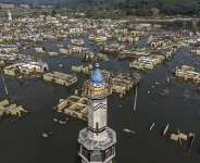An aerial view taken on July 30, 2026 shows a mosque and surrounding buildings in Somang village in Lebak in Indonesias western Banten province, which was deliberately flooded to make way for the construction and filling of the Karian Dam that opened in 2023 and has now re-emerged due to the El Nino-driven drought. Indonesia believes cloud seeding can help it tackle a wildfire season that experts say is on track to be among the worst in years, driven by a strong El Nino. -  Bay Ismoyo, AFP
