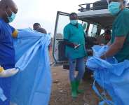 A health worker sprays a colleague with disinfectant after taking part in a burial service for 3-year-old Mave Mercienne, who died of Ebola, in Bunia, Ituri province, eastern Congo on August 18, 2026. -  Dieudonne Dirole, AP