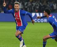 PSGs Desir Dou, left, celebrates scoring his sides opening goal during the French League One soccer match between Paris Saint-Germain and Brest in Paris, France, Sunday, May 10, 2026. - AP - Thibault Camus