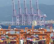 The container ship Panstar Acro is anchored at the new port of Busan before setting sail for Europe via the Arctic to test the commercial viability of the shipping route opened up by melting ice, in South Korea, on August 22, 2026. -  Jung Yeon-je, AFP