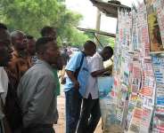 People read newspaper headlines in Lom, Togo. The Togolese government has been holding two French journalists and their local fixer in custody since late July. -  AFP/EMILE KOUTON