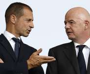 File - UEFA president Aleksander Ceferin speaks with Fifa president Gianni Infantino before the start of the UEFA Euro 2024 round of 16 football match between Switzerland and Italy at the Olympiastadion Berlin in Berlin on June 29, 2024. -  Odd Andersen, AFP