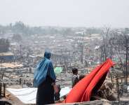 Rohingya refugees and humanitarians have faced unprecedented challenges in 2023, including fires, cyclones, and ongoing threats of monsoon-related disasters, putting their resilience to the test. Photo: IOM