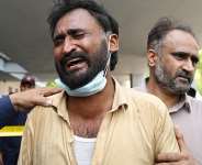 A man in tears outside the PIMS maternity ward, where a fire killed more than a dozen infants. -  Aamir Qureshi, AFP