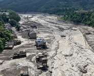 This aerial view shows houses laying partially submerged in muddy water along a riverside after flash floods at Trishuli Bazar in Nepals Nuwakot district on August 26, 2026. -  Prabin Ranabhat, AFP