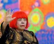 File - Japanese artist Yayoi Kusama waves at a photo session during a press preview of her exhibition titled My Eternal Soul at the National Art Center in Tokyo on February 21, 2017. -  Toshifumi Kitamura, AFP
