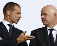 UEFA president Aleksander Ceferin speaks with FIFA president Gianni Infantino during a match at Euro 2024 in Berlin on June 29, 2024. -  Odd Andersen, AFP