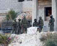 Israeli military forces carry the body of a Palestinian following the strike in Jenin, on August 28, 2026. -  Mohamad Torokman, Reuters