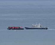 FILE - A boat carrying migrants is escorted by a vessel from the French Gendarmerie Nationale in the English Channel off Wimereux beach, France, on September 4, 2024. -  Nicolas Garriga, AP