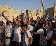 Israelis celebrate near Damascus Gate during the annual Jerusalem Day march commemorating Israels capture of East Jerusalem in 1967, 14 May. - AP Photo/Leo Correa - Leo Correa