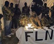 A meeting held in October 2006 between two journalists and spokespeople for the FLNC-UC, surrounded by masked and armed militants. -  AFP