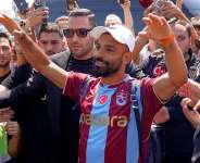 Egypts Mohamed Salah wearing his new Trabzonspor team jersey gestures to supporters as he arrives at the airport in Istanbul, Turkey, on August 5, 2026. -  Samet Yalcin, Dia Photo via AP