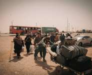 An Afghan family, including a woman with a disability and young children, crosses the border from Iran en route to IOM’s reception center in Islam Qala. Photo: IOM 2025/Mohammad Osman Azizi