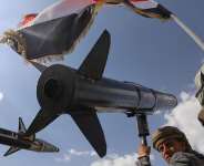 A Houthi supporter chants slogans as he carries a rocket replica during an anti-US and anti-Israel rally in Sana following Israeli airstrikes on September 26, 2025. -  Osamah Abdulrahman, AP