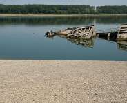 A man walks on a sandbank near wreckage of a German WWII warship which was exposed due to drought impacts on the Danube River in Serbia, August 4, 2026. -  Darko Vojinovic, AP