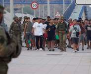 Escorted by the Spanish army, migrants who crossed into Spain return to Morocco from the Spanish enclave of Ceuta on Saturday, 1 August, 2026. - AP Photo/Antonio Sempere - Antonio Sempere