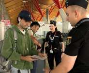 Spanish national police officers check the documents of travellers arriving from Italy, after Spains government said it would establish border controls for flights and ships from Italy, from midnight on Saturday until September 7, in a dispute over irregular migration, at Madrid-Barajas Airport in Madrid, Spain, August 8, 2026. -  Spanish police, via Reuters