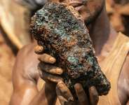 An artisanal miner holding a cobalt stone at the Shabara artisanal mine near Kolwezi, in Katanga, in October 2022. -  AFP/Junior Kannah