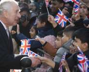 Charles III shakes hands during a visit to Brick Lane in London: The monarch enjoys a special status