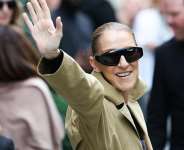 Canadian singer Celine Dion waves to fans as she arrives at Hotel Le Royal Monceau in Paris on 28 August 2026, ahead of her series of concerts in the French capital. - AFP - THOMAS SAMSON