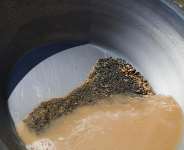 A pan containing gold-bearing sediment and heavy mineral concentrate sits at an artisanal mining site in Sudan on May 8, 2026. -  Mohnd Bla, AP