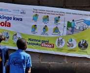Congolese children read an Ebola awareness poster in Bunia, Ituri province, in the Democratic Republic of Congo. - REUTERS - Gradel Muyisa Mumbere