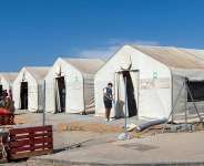 This picture shows large tents at the new Los Rosales migrant reception camp, where more than 800 people have been transferred from the Loma Colmenar camp, in Ceuta, on September 12, 2026. -  Antonio Sempere, AFP