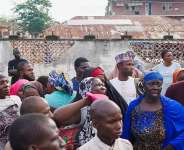 Families of illegal mining suspects who died while in detention gather outside the Minna General Hospital, where the bodies were taken. - REUTERS - Ibrahim Ndamitso