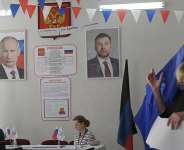 A woman leaves a voting booth during Russias parliamentary election at a polling station in Donetsk, Russian-controlled Ukraine, on September 20, 2026, amid the ongoing Russian-Ukrainian conflict. - stringer, AFP