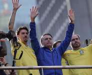 Former president Jair Bolsonaro, centre, waves to the crowd alongside his sons Jair Renan Bolsonaro (left) and Carlos Bolsonaro (second right), during a demonstration against his trial at the Court of Justice of the Republic, So Paulo, Sunday, June 29, 2025. - Ettore Chiereguini, AP