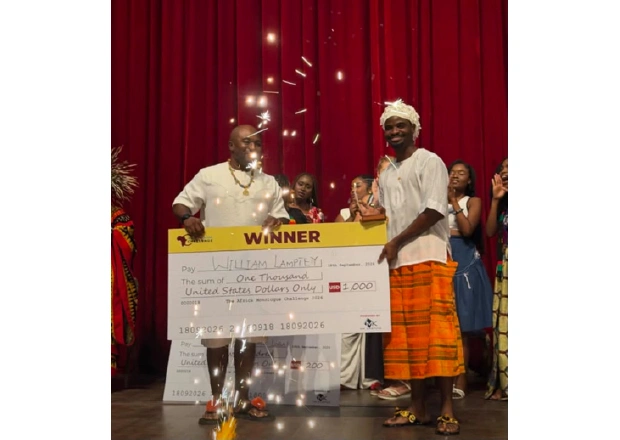 William receiving his prize from Roger Qartey