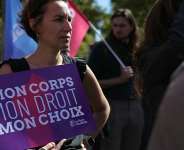 A woman holds a placard reading My body, my right, my choice during a demonstration for the right of abortion on the occasion of International Safe Abortion Day in Paris on 28 September 2025. - AFP - THOMAS SAMSON