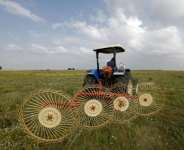 A farmer uses a hay-collecting machine in a field in the Zehiliga region of Morocco. Rising fertiliser costs are threatening the livelihoods of many farmers.  By Abdel Majid BZIOUAT (AFP)