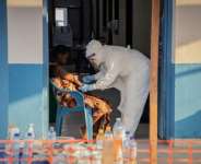 A healthcare worker taking samples from an Ebola patient in Bunia, northeastern DR Congo.  By Benediction MURHABAZI (AFP)