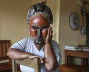 A woman deported from the US to Cameroon in an immigration crackdown shields her face with a mask as she poses for a photograph in Yaounde on September 9, 2026.  By - (AFP)