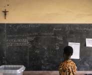 An electoral official views early results during counting at a polling station in Porto-Novo.  By OLYMPIA DE MAISMONT (AFP)