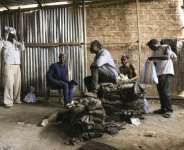 Artisanal miners prepare to descend into the mine shaft, in Kolwezi, where the race is on for critical minerals as the boundary between urban space and mining land fades. By MARIE RUWET (AFP)
