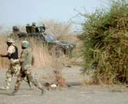 Soldiers on patrol close to a former Boko Haram camp near Maiduguri, northeast Nigeria on June 5, 2013.  By Quentin Leboucher (AFP/File)