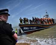 British MPs said there was no clear evidence the governments plan to deport some asylum seekers to Rwanda would discourage Channel crossings.  By Ben Stansall (AFP)