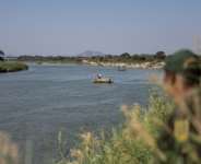 Hundreds of people cross into South Africa through the Limpopo River.  By EMMANUEL CROSET (AFP)