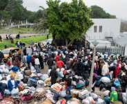 Hundreds of Zimbabweans gathered outside the Zimbabwean Consulate in Cape Town last month, seeking help to leave South Africa.  By RODGER BOSCH (AFP)