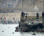 Many of the migrants have been swimming around a border barrier to get to Cueta. By JORGE GUERRERO (AFP)