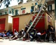 Migrants sit outside the CETI short-stay migrant centre in the Spanish North African enclave of Ceuta.  By Henry Nicholls (AFP/File)