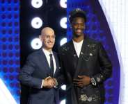 NBA commissioner Adam Silver shakes hands with AJ Dybantsa after he is chosen by the Washington Wizards with the top pick in the NBA Draft.  By Arturo Holmes (GETTY IMAGES NORTH AMERICA/AFP)